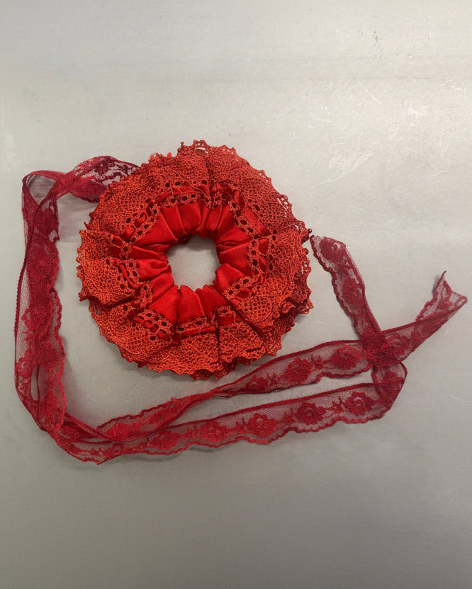 Red lace scrunchie with a strap on a white background