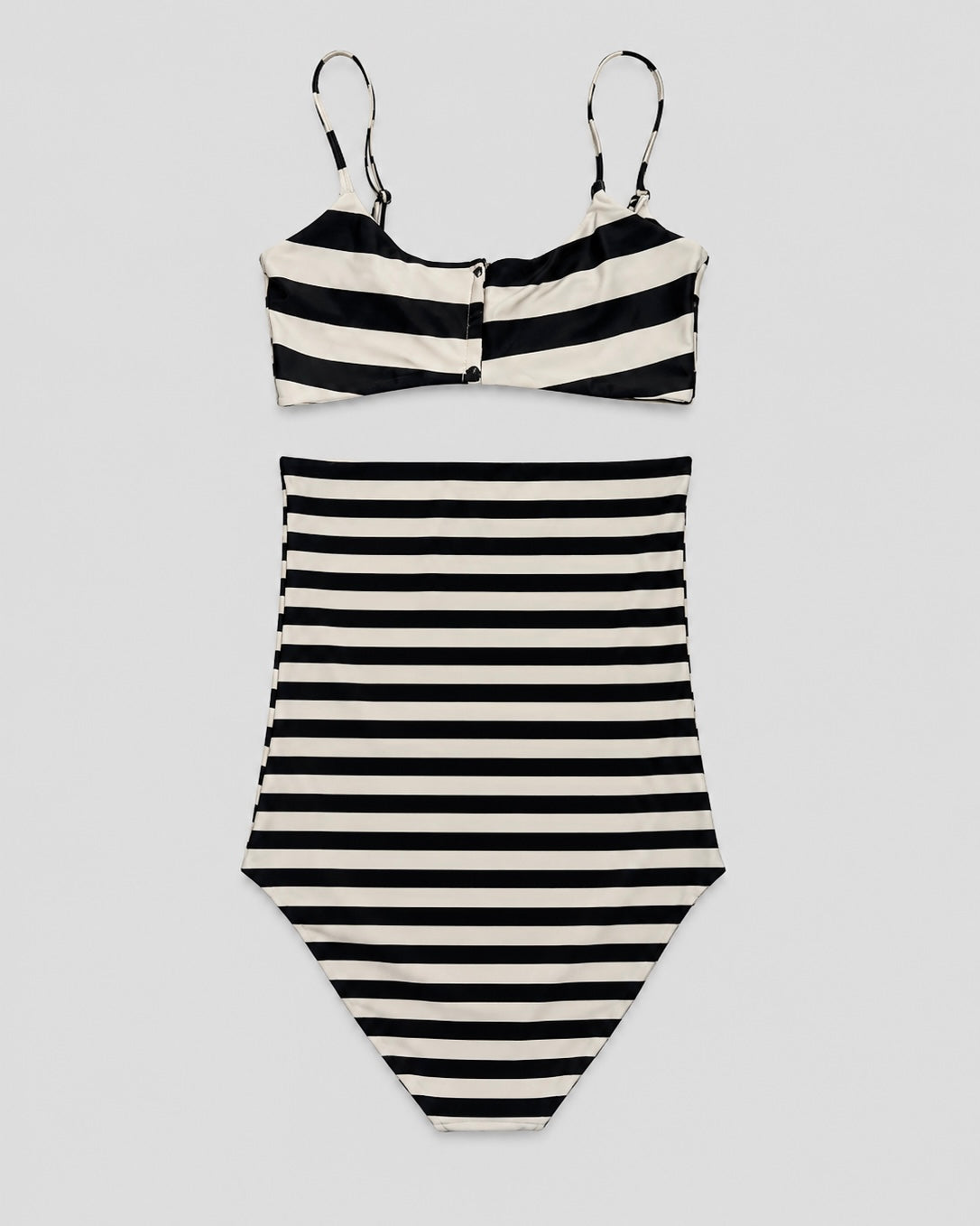 Black and white striped swimsuit on a light gray background