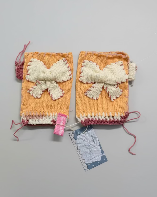 Two knitted items with white floral patterns on a gray background