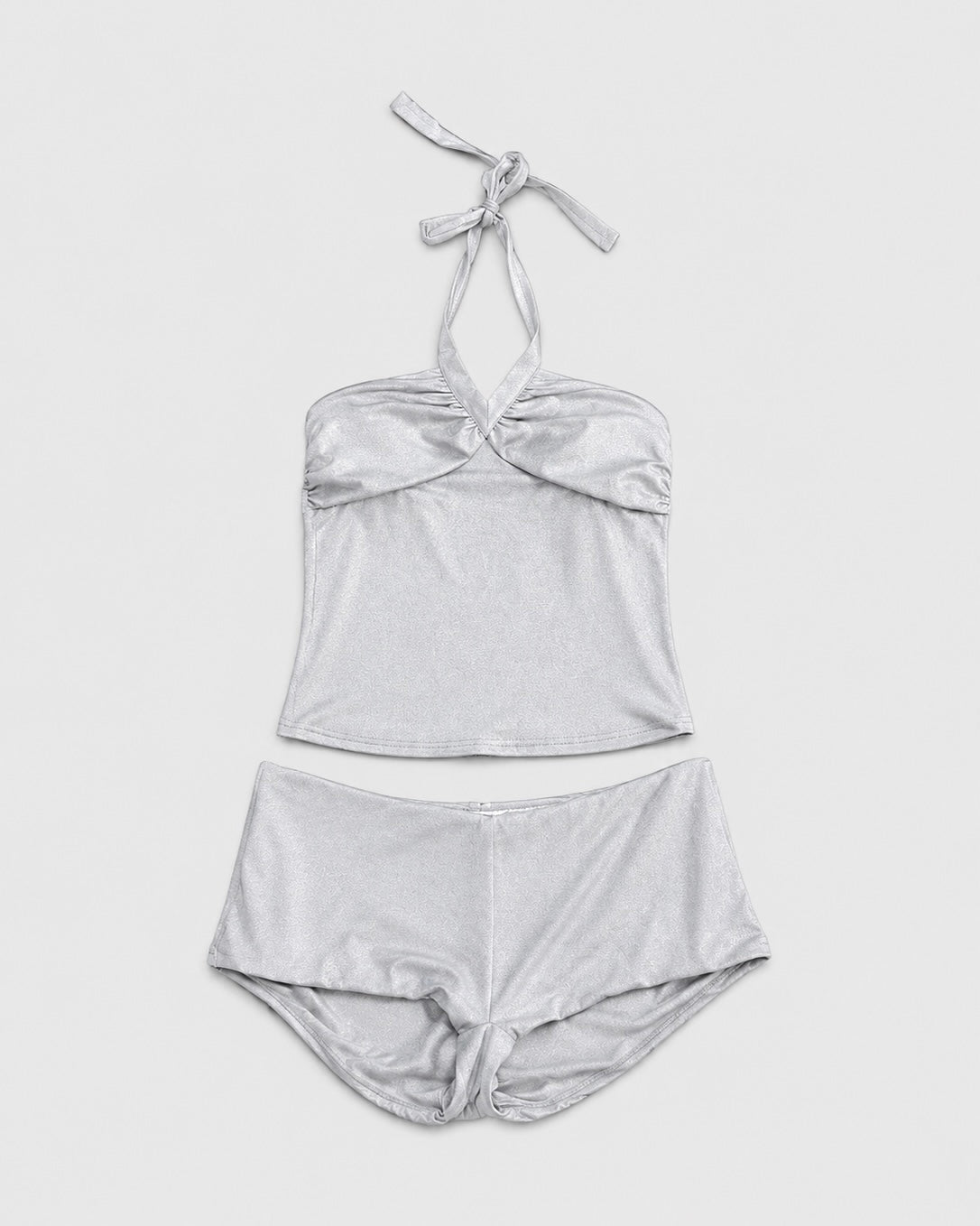 Silver bikini set on a light gray background